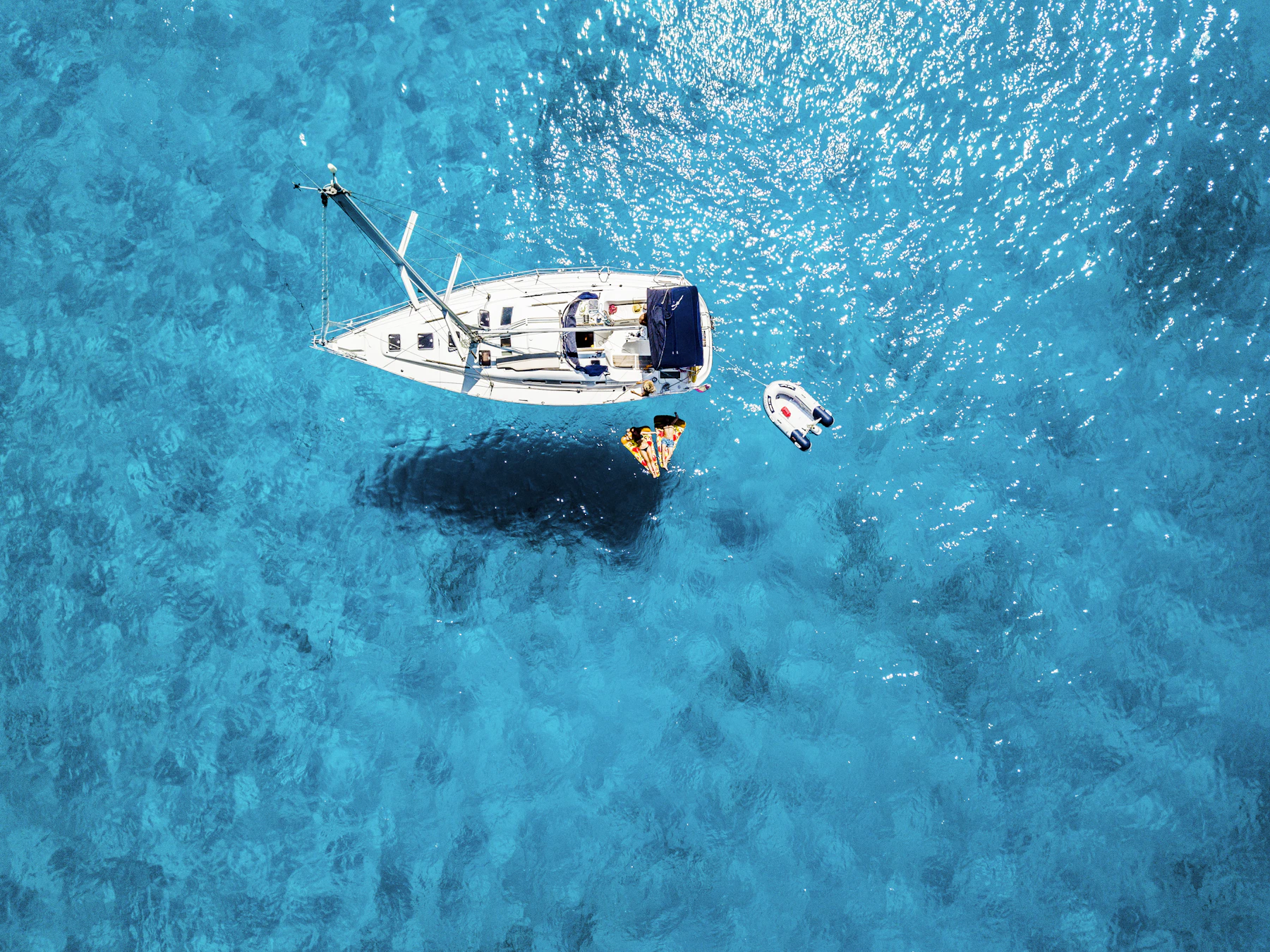 A sailboat anchored in clear turquoise water